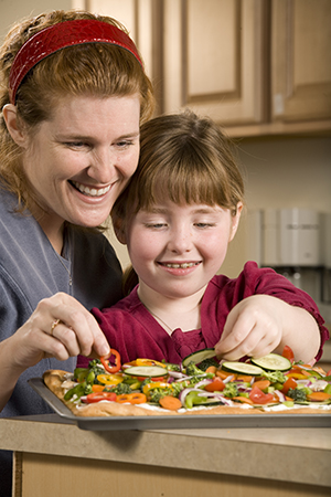 Mother and daughter cooking.