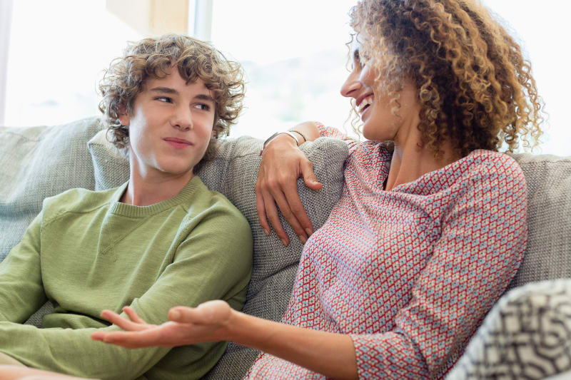 Mother talking to her tennage son.