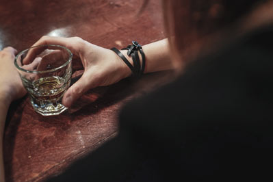 Woman drinking glass of alcohol