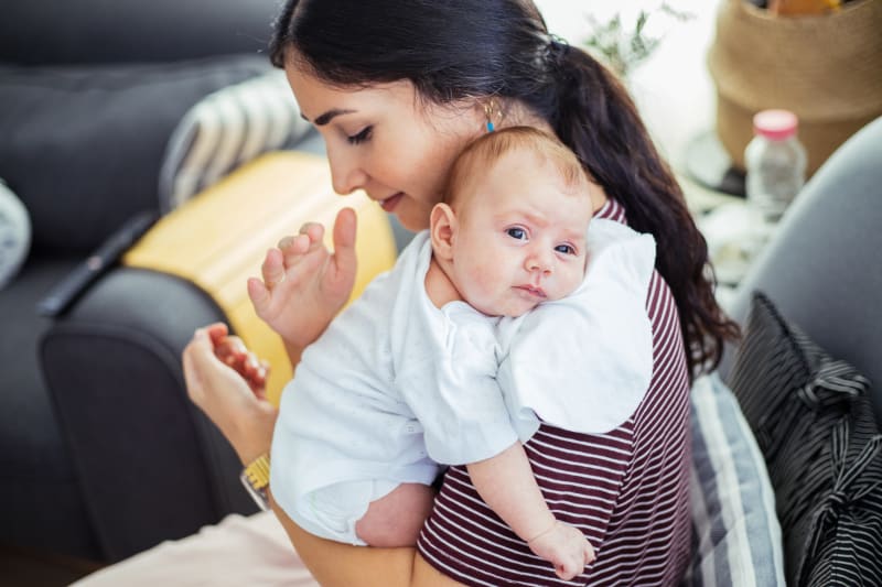 Mother burping her baby.