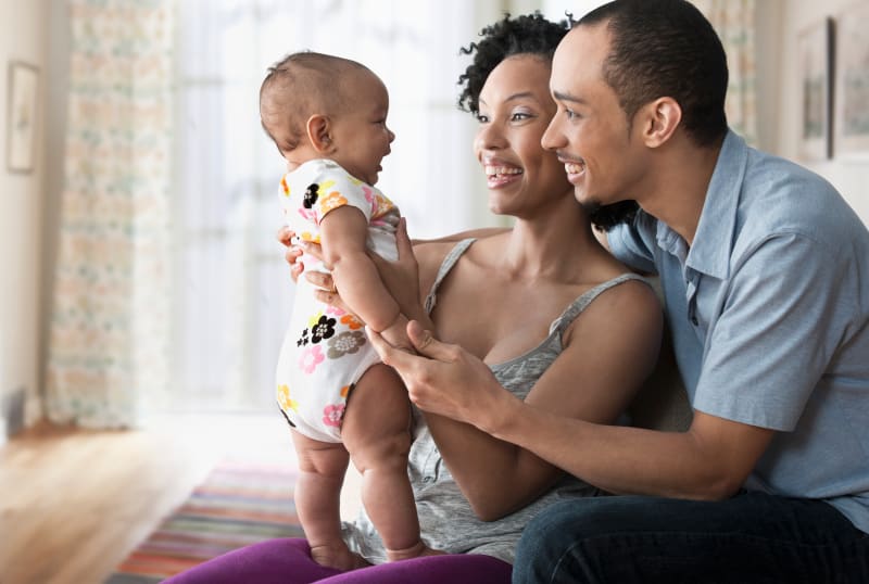 Mother and father bonding with their baby.