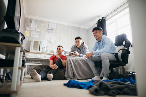 Group of teenage boys playing video games